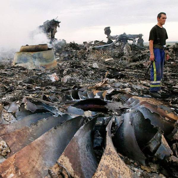 An Emergencies Ministry member walks at the site of a Malaysia Airlines Boeing 777 plane crash near the settlement of Grabovo in the Donetsk region, July 17, 2014.