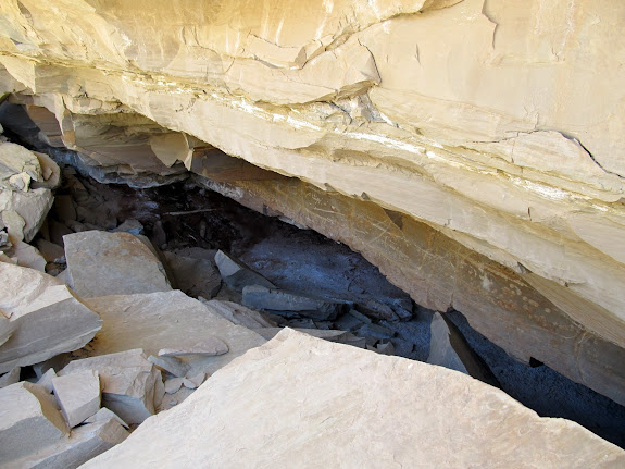 An alcove with some fairly recent rockfall in front of it