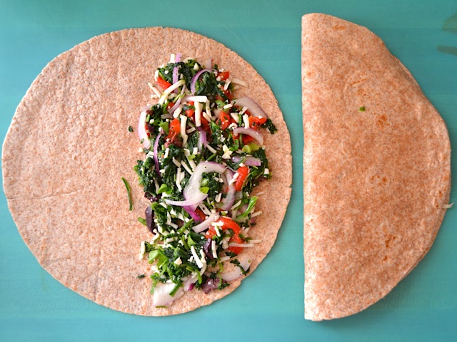 whole tortilla with filling placed on half and the other half folded over 