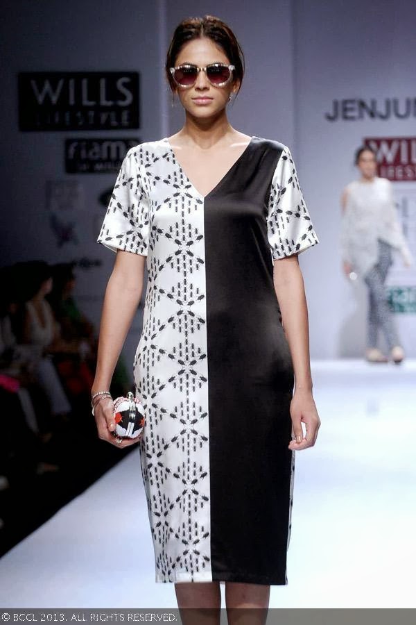 A model showcases a creation by fashion designer Jenjum Gadi on Day 3 of Wills Lifestyle India Fashion Week (WIFW) Spring/Summer 2014, held in Delhi.