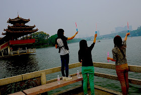 young women making bubbles at a park in Changsha, China