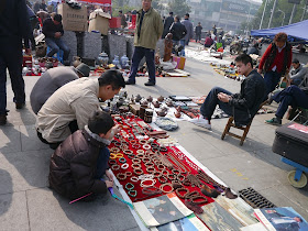 man and boy looking at items at an outdoor antique market in Changsha, China