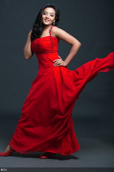 Koshri looks great in red while she strikes a pose during a photoshoot.
