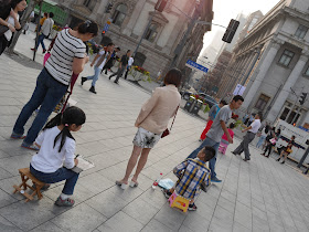 girl and boy drawing buildings at The Bund in Shanghai