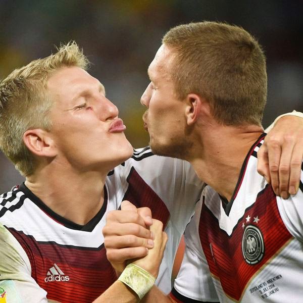 Germany's midfielder Bastian Schweinsteiger (L) and Germany's forward Lukas Podolski celebrate after winning the 2014 FIFA World Cup final football match between Germany and Argentina 1-0 following extra-time at the Maracana Stadium in Rio de Janeiro, Brazil, on July 13, 2014. 