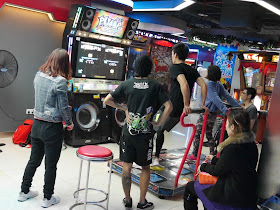 people playing a dance video game in D-Mall in Shanghai