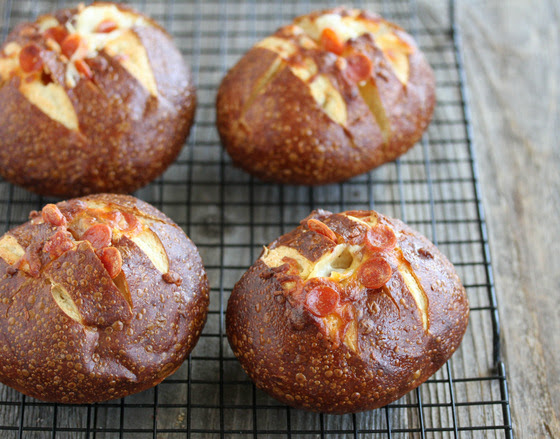 photo of four Pepperoni Pizza Pretzel Rolls on a baking rack