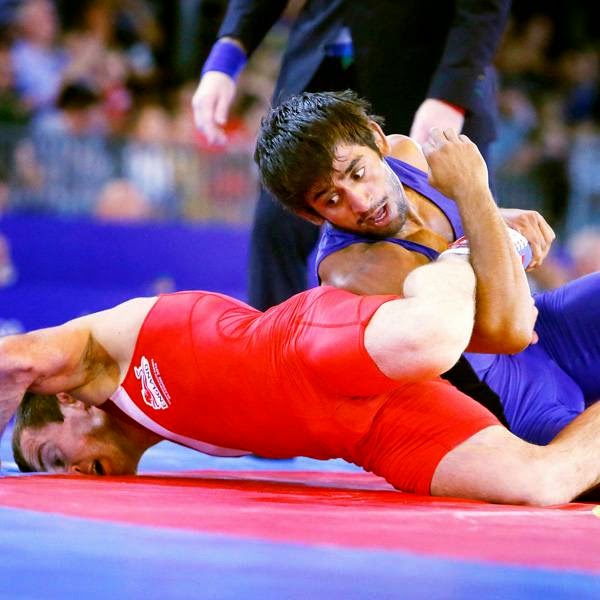 England's Sasha Madyarchyk, red, and India's Bajrang during the FS 61 kg Round of 16 Wrestling at the Scottish Exhibition Conference Centre, during the 2014 Commonwealth Games, in Glasgow, on July 30, 2014.