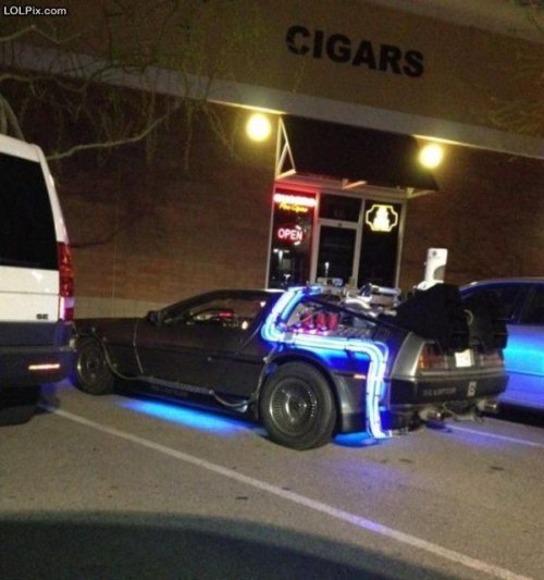 photo of the car from Back to the Future parked in front of a cigar store