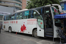 blood donation bus with cartoon image of two walking blood droplets in Kunming