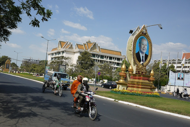 monk as a passenger on a motorbike