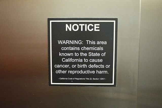 sign with message "NOTICE. WARNING: This area contains chemicals known to the State of California to cause cancer, or birth defects or other reproductive harm. California Cod of Regulations Title 22, Section 1260."