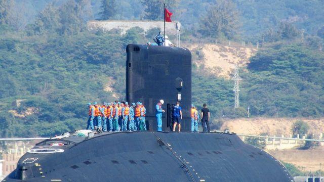 on January 3, 2014 shows the Vietnamese Navy's first submarine class Kilo 636 (C) named 'Hanoi' being released into the sea from a Netherland's transporting ship Rolldock Sea at Cam Ranh Bay in central Vietnam.