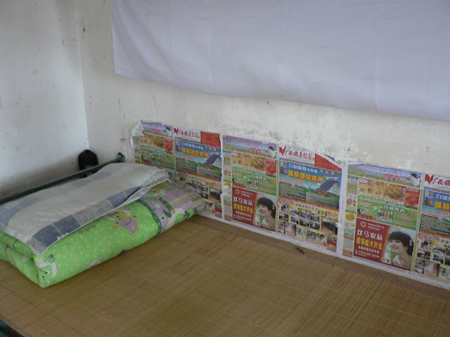 wall covering next to a dorm bed at the Guangxi Normal University for Nationalities in Longzhou, China