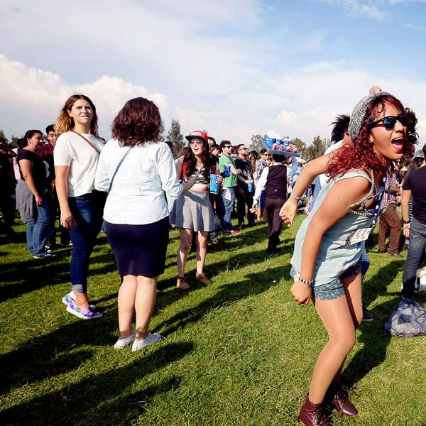 People attend British DJ Chris Lake's performance during the the first Day of the Corona Capital Music Fest at the Hermanos Rodriguez racetrack, in Mexico City, on October 12, 2013.
