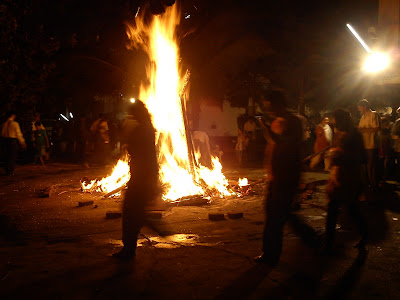 People circumabulating the Holika Dahan fire during the Holi festival in India