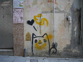 graffiti on a wall of a cat and a heart