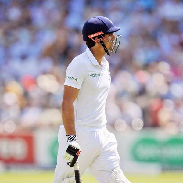 England's Alastair Cook walks towards the pavillion after being caught out behind by India's Mahendra Singh Dhoni off the bowling of Bhuvneshwar Kumar for 10 runs during the second day of the second Test cricket match between England and India, at Lord's Cricket Ground in London, England on July 18, 2014. 