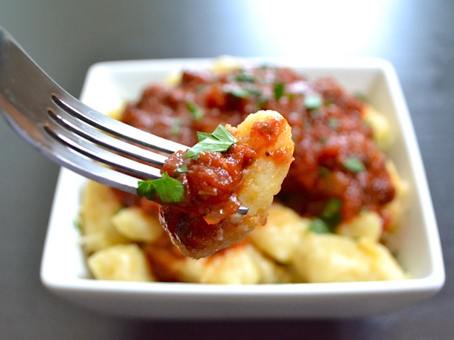 close up of a fork of gnocchi with red sauce 