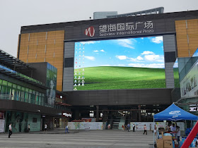 giant screen in front of the Seaview International Plaza displaying a Windows OS desktop