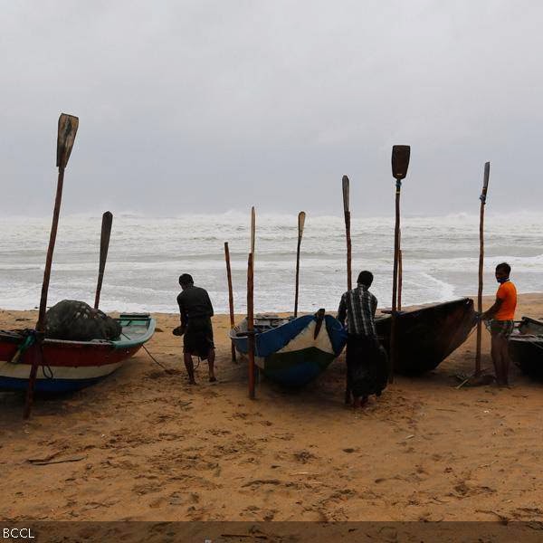 Fishermen tie their boats along the shore before leaving for a safer place at Donkuru village in Srikakulam district