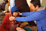 Hiro-san passing out some of the hand-knitted items to a grateful lady in Tohoku.