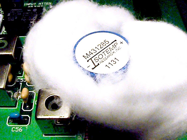 A
                    wad of cotton is in place around all the exposed
                    temperature sensitive components of the Elecraft
                    XV144 transverter 116 MHz Local Oscillator. Sterling
                    Coffey NSSC demonstrated this frequency
                    stabilization technique on
                    http://www.youtube.com/watch?v=wXkhsfEDIok