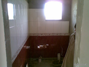 Bath room tile work commences