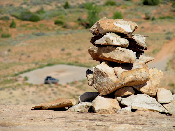 Cairn at the top of the mesa with Jeep in the background
