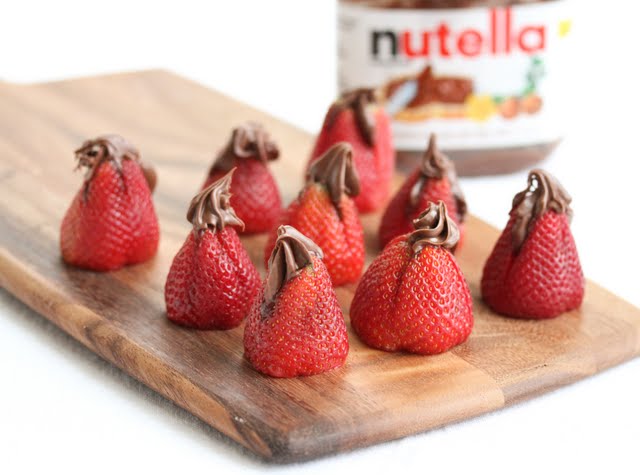 photo of Nutella Stuffed Strawberries on a cutting board