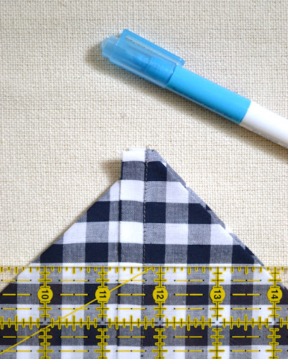 Line up one side of your non-slip ruler with the drawstring channel edge. Using your water soluble marker, draw a line approx. 1 (1 1/2, 2, 2 1/2, 3) inches from the point of the corner. Line up one side of your non-slip ruler with the drawstring channel edge. Using your water soluble marker, draw a line approx. 1 (1 1/2, 2, 2 1/2, 3) inches from the point of the corner.