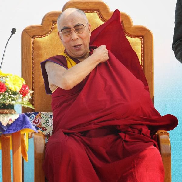 Tibetan spiritual leader the Dalai Lama, adjusts his robe after delivering a lecture at the Nehru stadium in Gauhati, India, Sunday, Feb. 2, 2014.