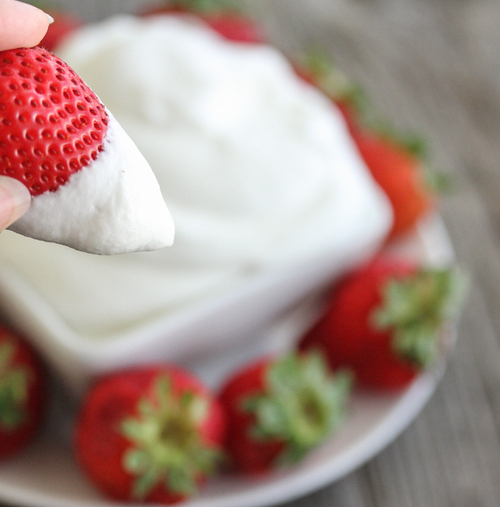 close-up photo of a strawberry with coconut whipped cream