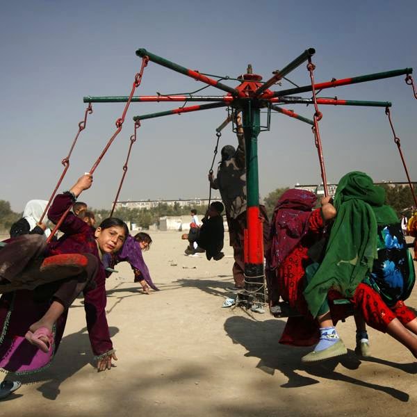 Afghan children sit on a carnival ride during Eid al-Fitr, in Kabul.