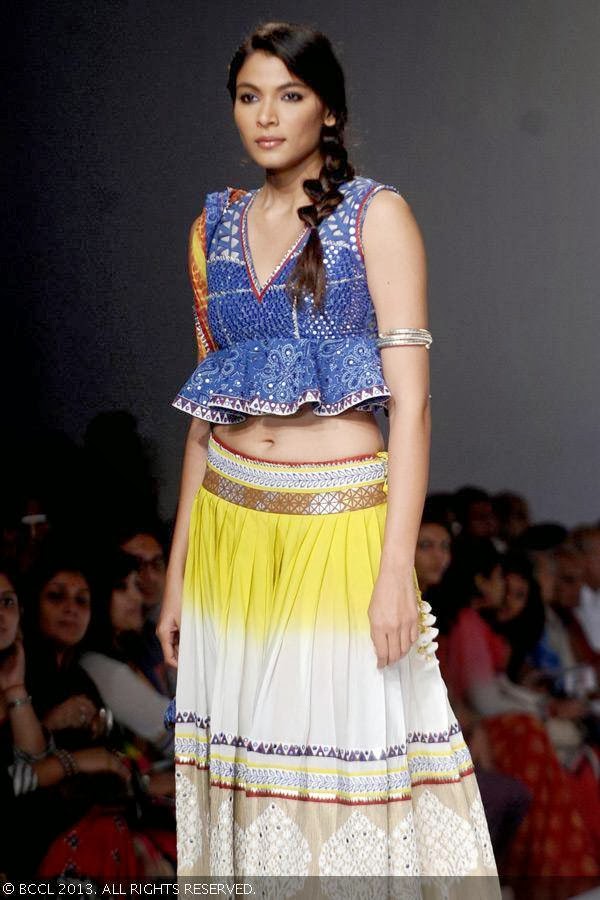 A model showcases a creation by fashion designer Poonam Dubey on Day 4 of Wills Lifestyle India Fashion Week (WIFW) Spring/Summer 2014, held in Delhi.