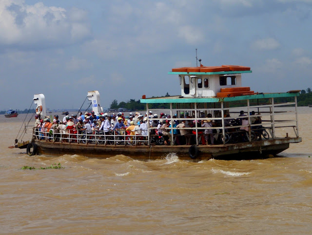 Motos and peeps ferrying across the Mekong