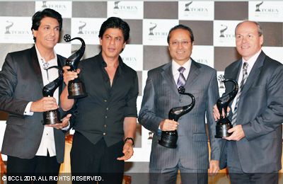 (L-R) Shiamak Davar, Shah Rukh Khan, Vineet Jain, MD Times Group and Jim Nickel, Acting Consul General and Deputy High Commissioner of Canada during the photoop at the unveiling of 'Times of India Film Awards' trophy, held in Mumbai on January 29, 2013.