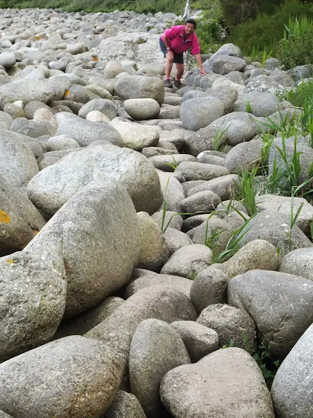 NAviagting across the large pebbles at St Loy's Cove