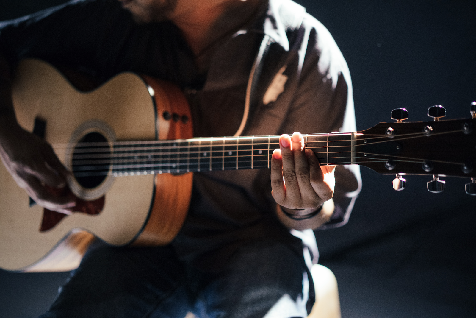 Man holding an acoustic electric guitar
