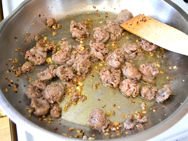 sausage squeezed out of casing into pan with oil, red pepper flakes and garlic 
