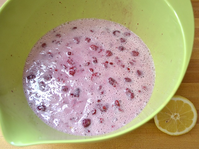 raspberries added to wet ingredients in mixing bowl 