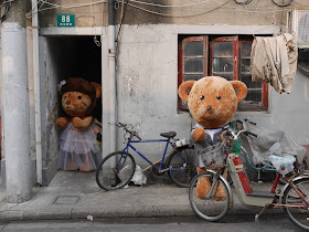 two large stuffed bears dressed up for a marriage
