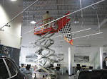 Installation of hanging promo banners at Downtown Porsche