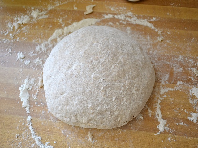 ball of dough on floured counter top 