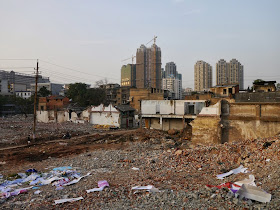 a view from a small hill of Beizheng Street with tall buildings being built in the background