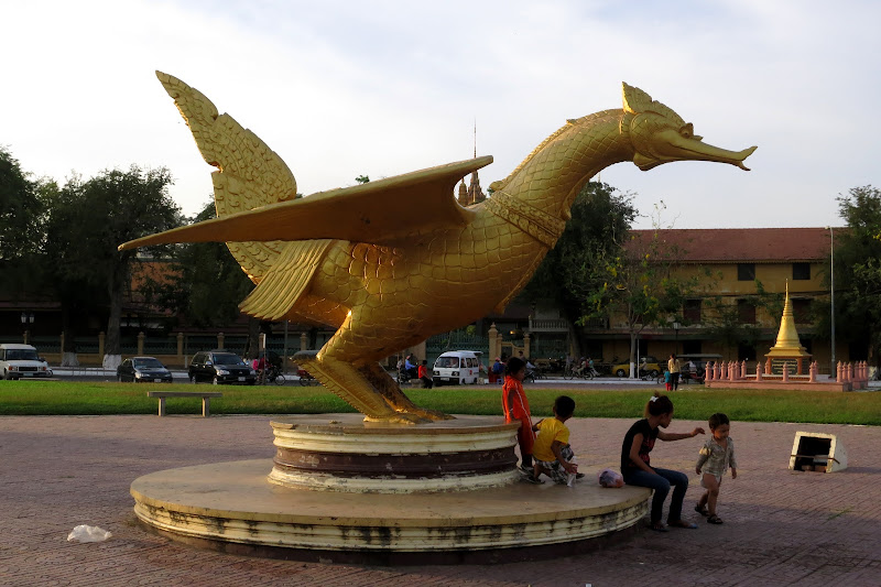 Children playing around Garuda statue