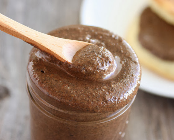 close-up photo of a spoon dipping into a jar of cookie butter