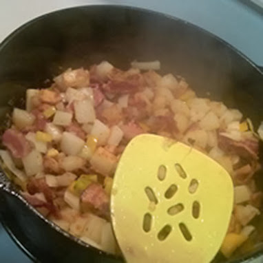 adding peppers, onions and bacon to potatoes for frittata