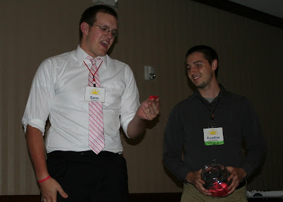 DYNA Youth Ambassador, Sam Lensmire, and volunteer, Austin Raimond, select the winning raffle ticket.