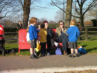 children at red metal bench in park